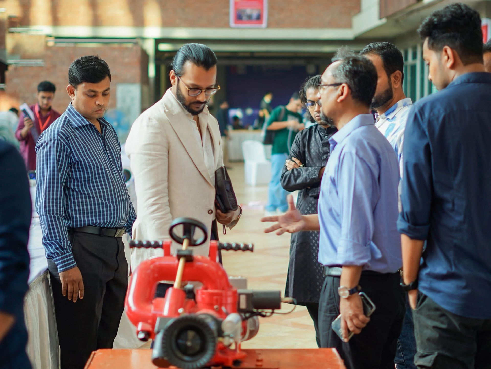 Visitors examining the FireGuard water monitor at the WICE exhibition