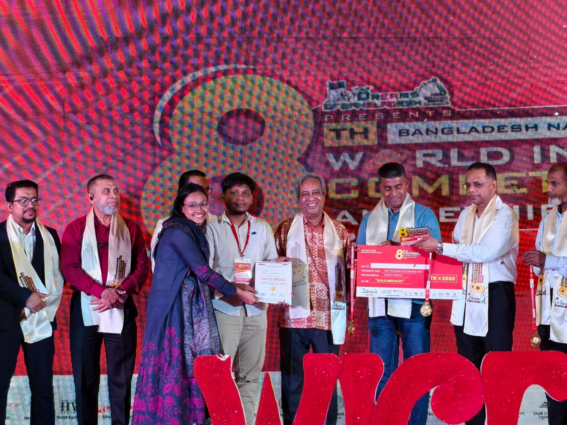 Infernotics team receiving a gold medal certificate and award