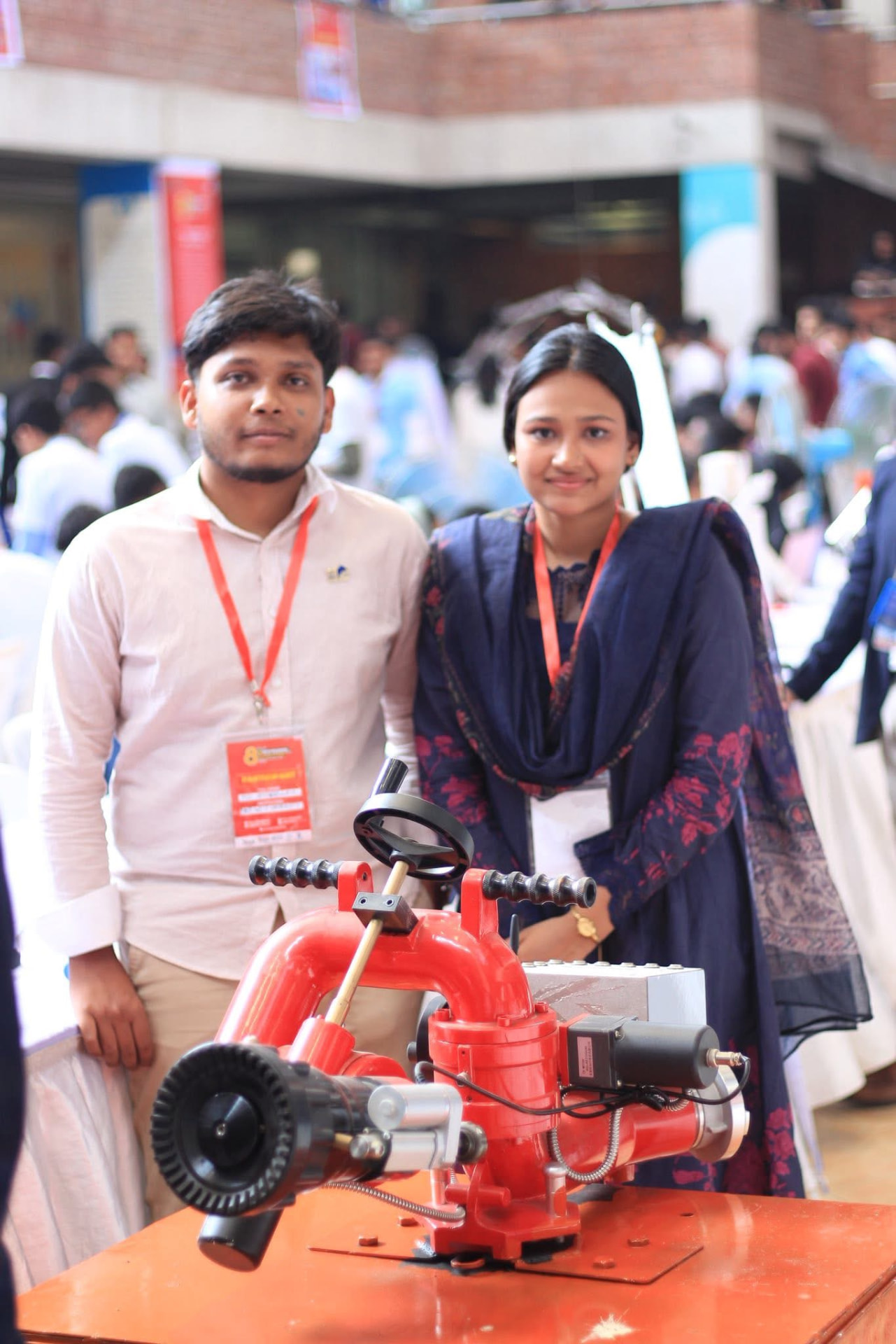 Two Infernotics team members presenting the FireGuard water monitor at WICE